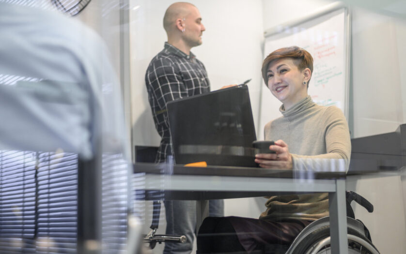 Woman in wheelchair with coworkers