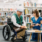 Person in wheelchair talking with staff