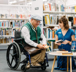 Person in wheelchair talking with staff