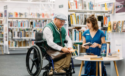 Person in wheelchair talking with staff