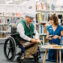 Person in wheelchair talking with staff