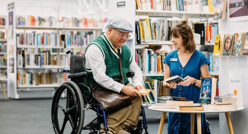 Person in wheelchair talking with staff