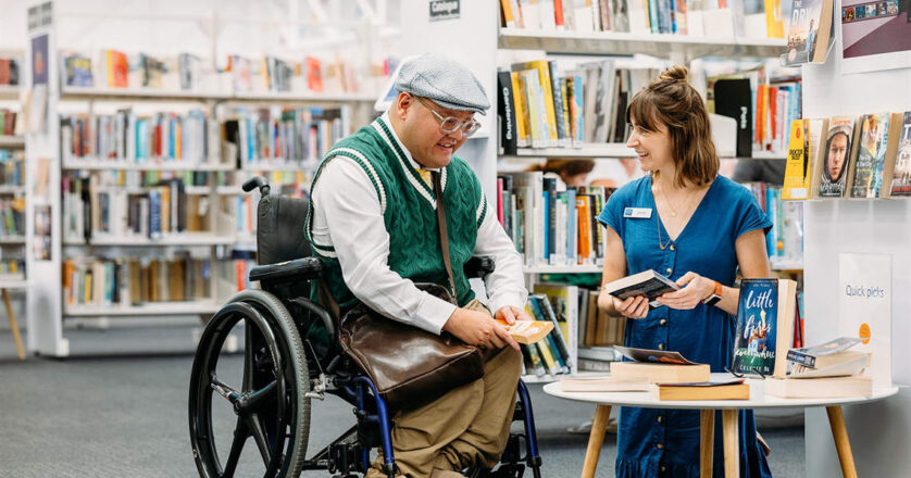 Person in wheelchair talking with staff