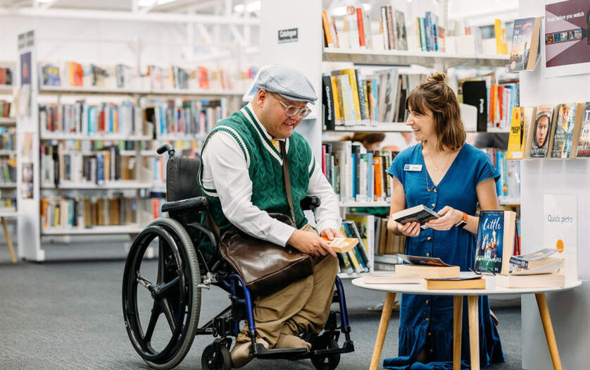 Person in wheelchair talking with staff