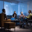 woman in wheelchair with colleagues working in office