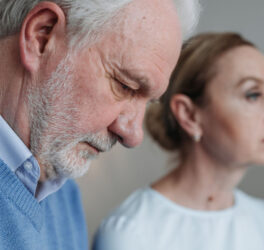 Close-up portrait of an elderly couple experiencing deep emotions and reflection.
