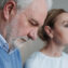 Close-up portrait of an elderly couple experiencing deep emotions and reflection.