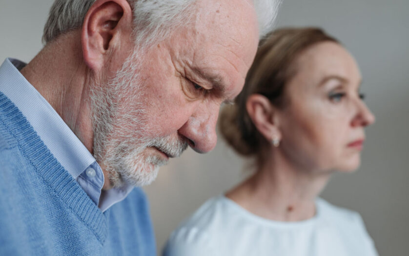 Close-up portrait of an elderly couple experiencing deep emotions and reflection.