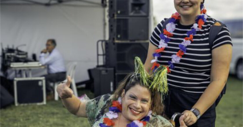 Woman in wheelchair celebrating Australia Day with her carer