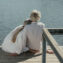 A senior couple enjoys a peaceful moment sitting together on a wooden dock by the lake
