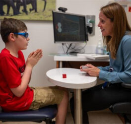 A neuropsychologist works with a child with autism.