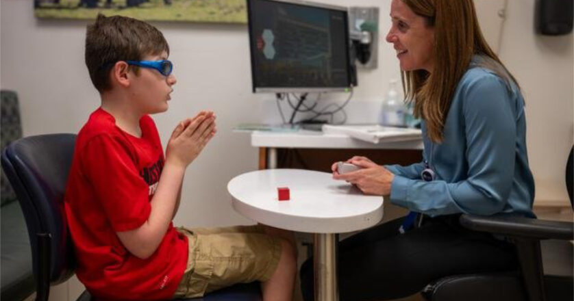 A neuropsychologist works with a child with autism.