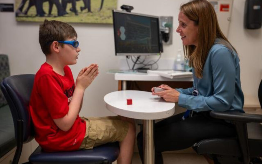 A neuropsychologist works with a child with autism.