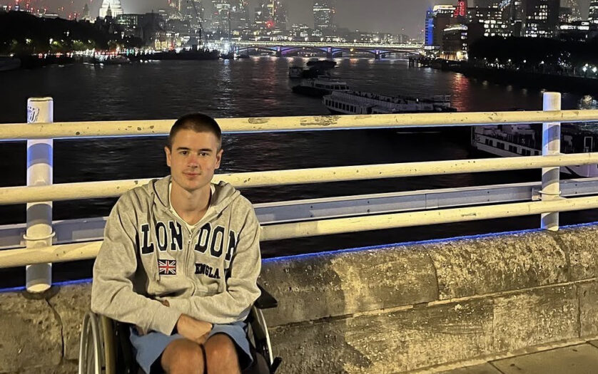 Liam Virgo in his wheelchair on a footbridge, London